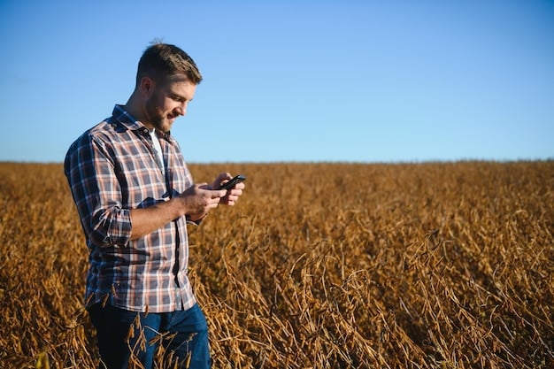 A farmer standing next to a combine harvester in a large field, using a smartphone to view diagnostic data. The sky is partly cloudy, indicating a busy but potentially challenging harvest day.