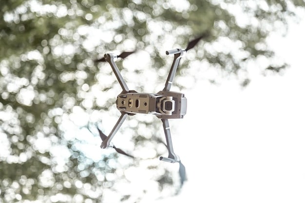 A close-up shot of a multi-spectral camera mounted on a drone, with the lens focusing on a field of crops. The camera captures detailed data on plant health, displaying chlorophyll levels and other vital signs.
