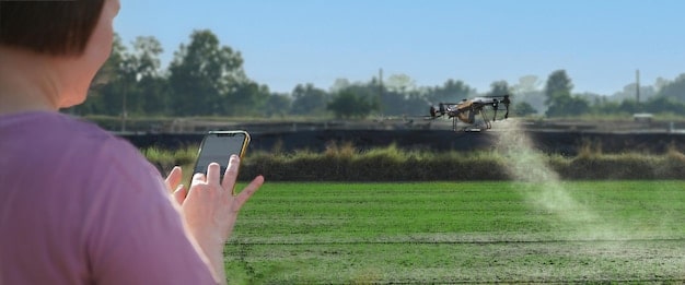 A split-screen image showing traditional tractor spraying on one side and drone spraying on the other, highlighting the differences in efficiency and coverage.