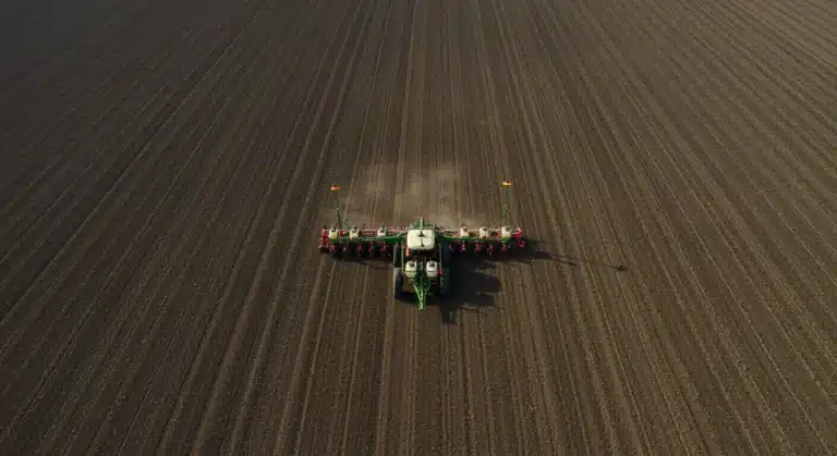 Modern precision planter with GPS technology in action on a large farm field