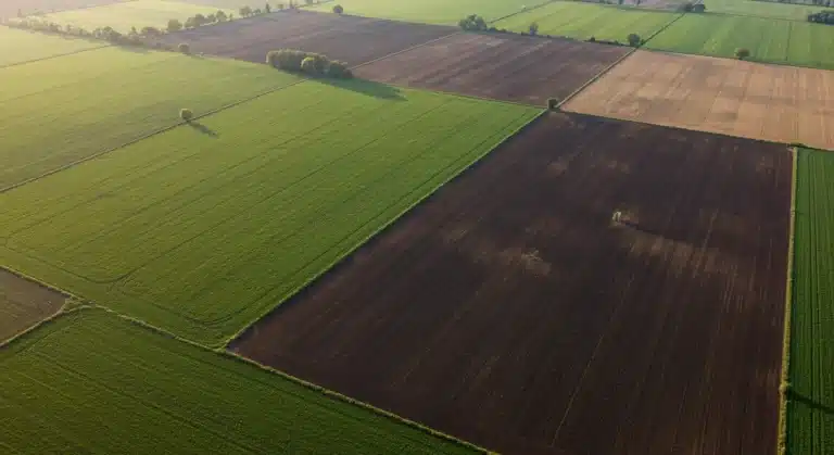 Aerial view of diverse farm fields demonstrating carbon sequestration practices