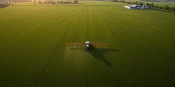 Drone view of farm field with precision agriculture planter applying fertilizer.