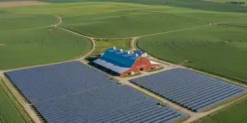 Aerial view of a farm with solar panels and wind turbines, symbolizing sustainable energy.